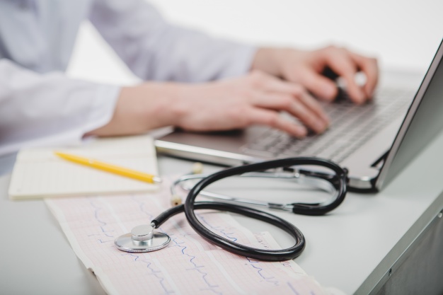 crop-doctor-typing-laptop_23-2147648748